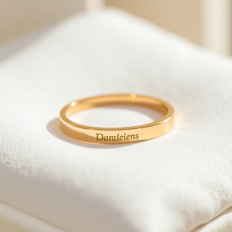 Detailed shot of an engravable gold baby bracelet on white velvet