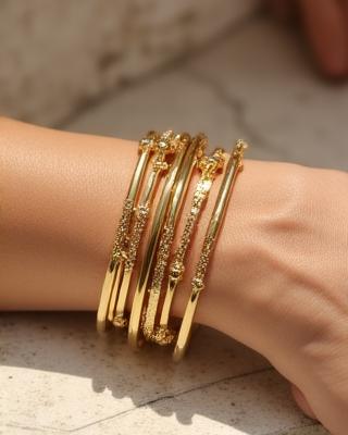 Demi-fine bangles on wrist